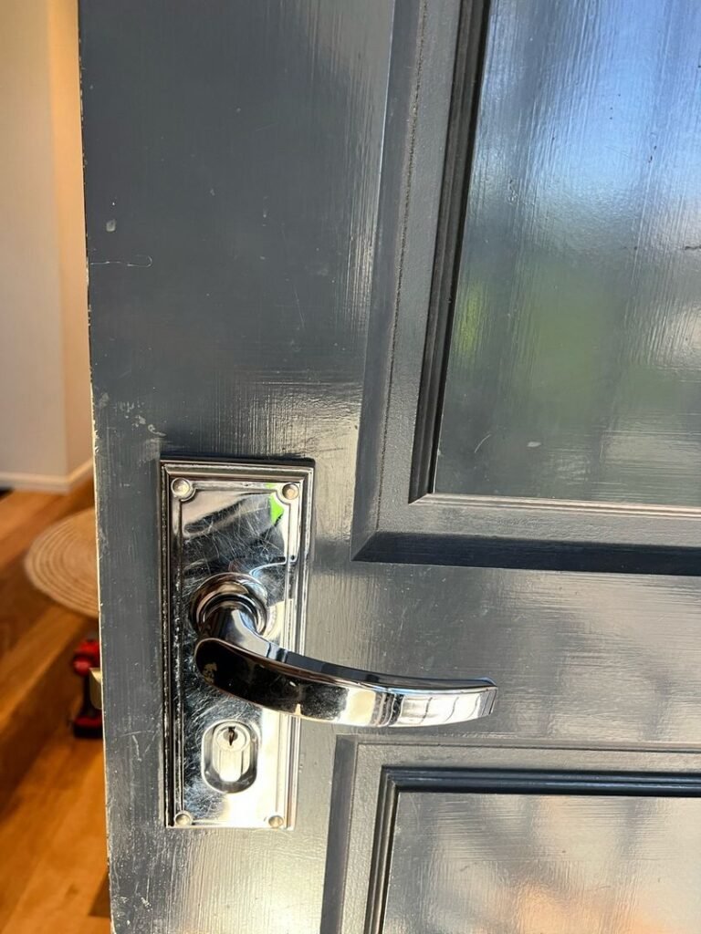 Close-up view of a door with a metallic handle and lock mechanism.