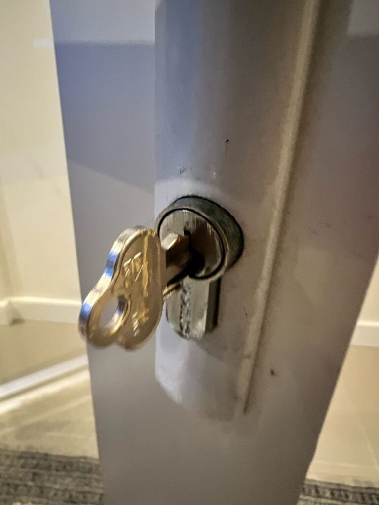 Close-up of a broken key stuck in a door lock.